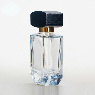 Botella de perfume de cristal vacía con el casquillo negro de madera del collarwith del espray del casquillo y de la bomba