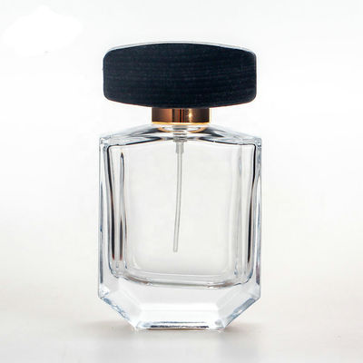 Botella de perfume de cristal vacía con el casquillo negro de madera del collarwith del espray del casquillo y de la bomba